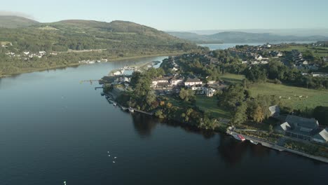 killaloe town along a peaceful river with lush hills in county limerick, ireland, aerial view