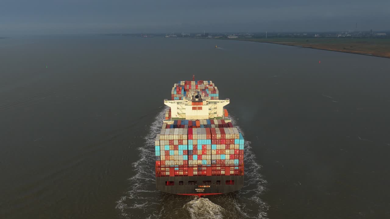 Aerial shot of container ship moving through busy trade corridor