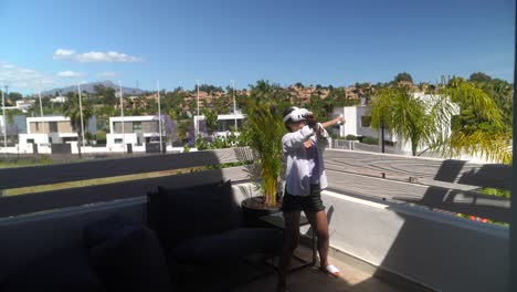 woman experiencing vr on a balcony