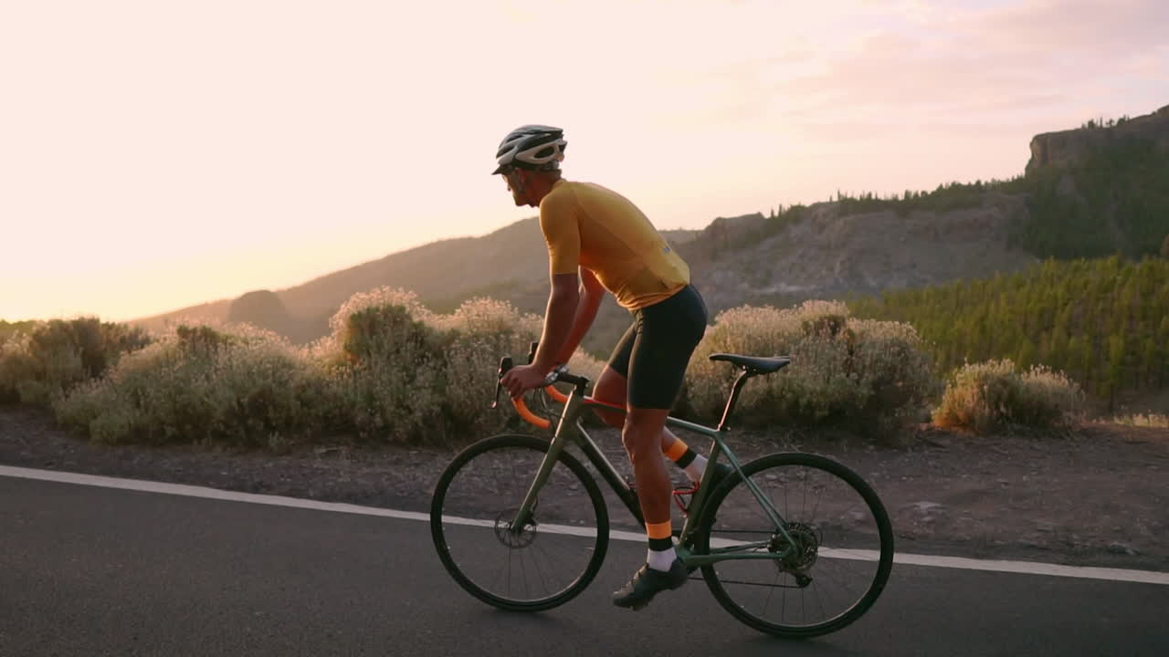 Cycling through a mountain serpentine in slow motion, the athlete enjoys the island's breathtaking view, a testament to the pursuit of a healthy lifestyle