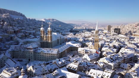 Push-in-aerial-video-of-the-old-town-covered-with-snow,-Sankt-Gallen,-St