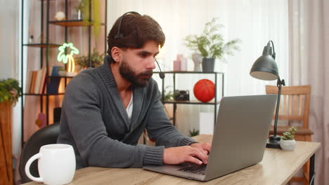 indian man in headset at laptop friendly support agent listens writes key points customer care calm