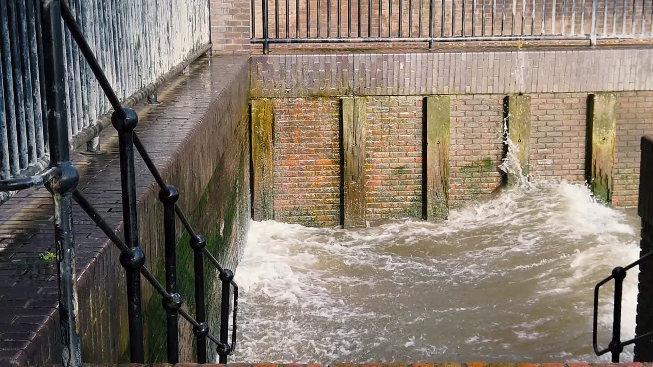 One big splash of Thames, smashing into a brick wall, slow motion.