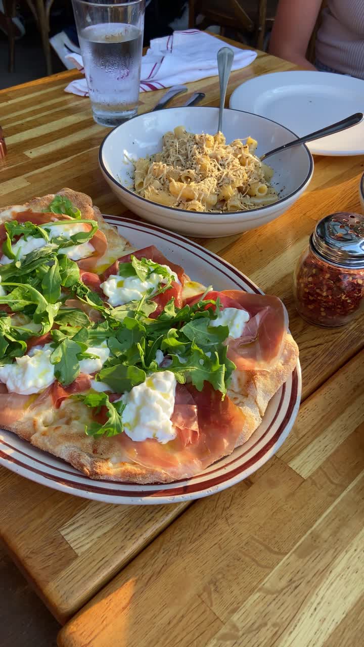 Pov of delicious tasty lunch in Italian restaurant serving salads and pasta. Table full or quality food dishes. Point of view of internet vlogger influencer filming and uploading to social media