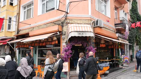 people walking past a cafe in balat, istanbul