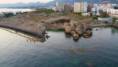 Aerial-zoom-in-of-the-sea-caves-at-the-Girne-harbor-in-Cyprus