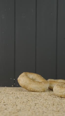 freshly baked bagels batch bouncing on poppy seeds