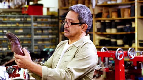 zapatero examinando un zapato
