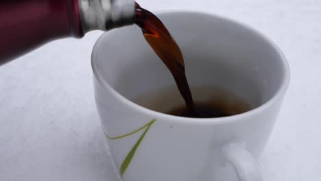 satisfying video of warm black tea pouring in ceramic cup