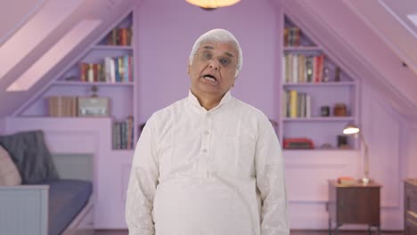 sleepy and tired indian old man yawning