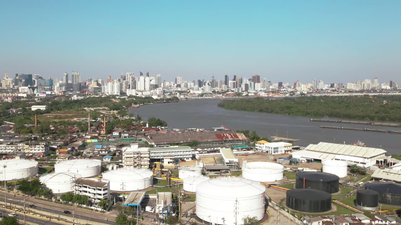 Aerial view of Bangkok's skyline with industrial buildings and river