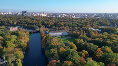 schloss bellevue palace nestled among vibrant autumn foliage in tiergarten park, berlin, germany. panorama overview drone