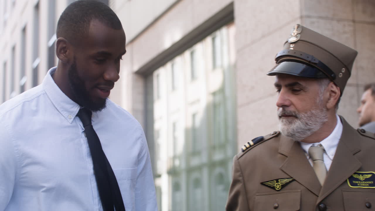 Two men walking and talking on the street