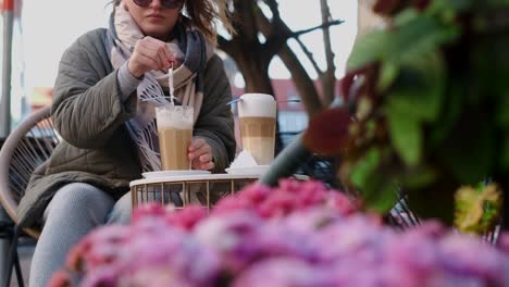 woman enjoying a latte in an outdoor cafe