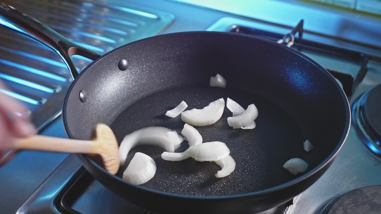 Sauteing Chopped White Onions With Green And Red Bell Peppers In A Pan