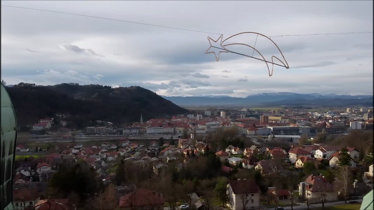 Aerial flying between two church towers and revealing Celje picturesque cityscape