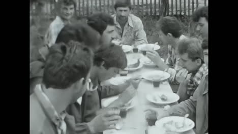 A Group of Men Enjoying a Meal Together at a Table. CIRCA USSR 1980s: Men from the Soviet Union gathered around a table, sharing food and engaging in conversation.