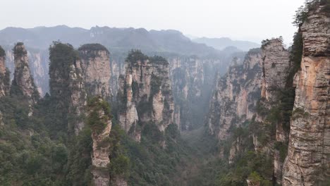 an expansive drone shot capturing the iconic rock formations and lush valleys of zhangjiajie, china, offering a stunning view of this famous natural landscape