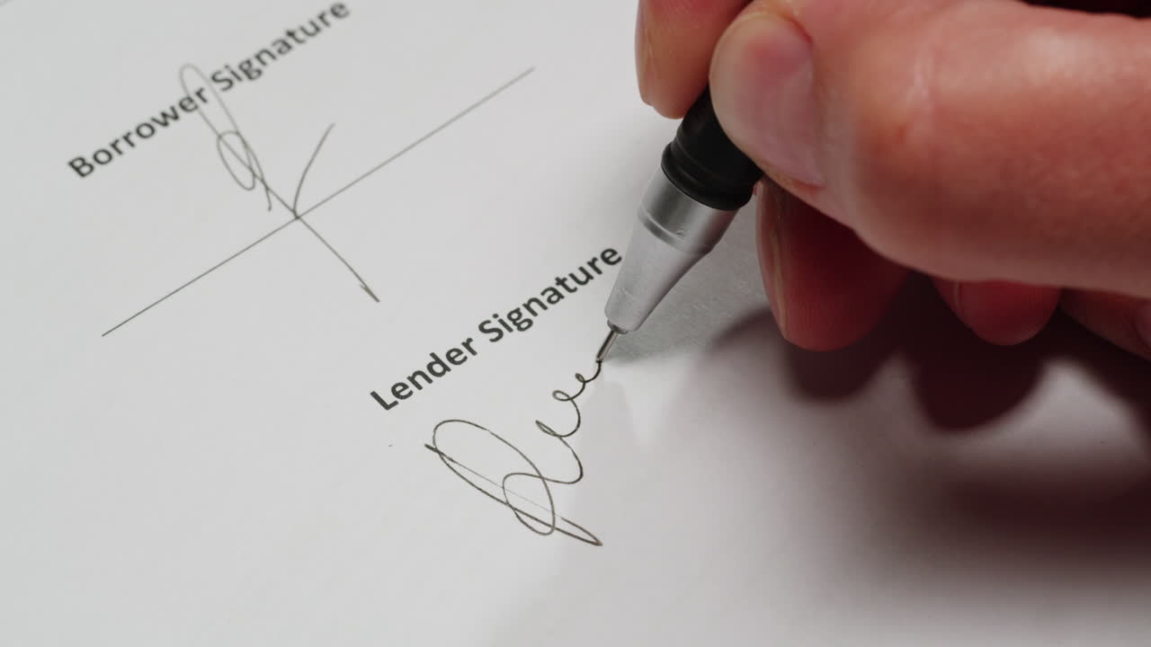 Close-Up of Hand Signing Lender Signature on a Document
