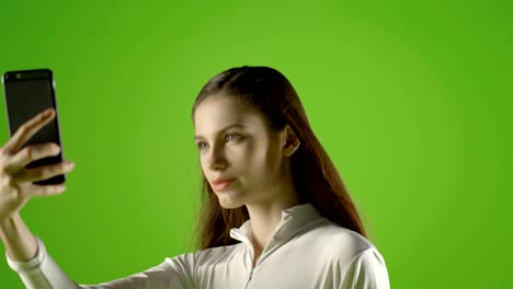 attractive girl young fashion model interract with her smartphone and take selfie greenscreen prores shoot on ursa mini pro