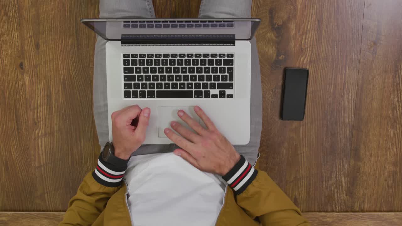 Caucasian man using a laptop
