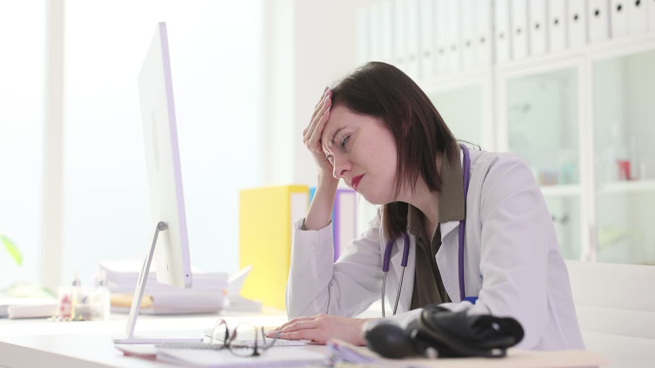 Frustrated doctor working at computer