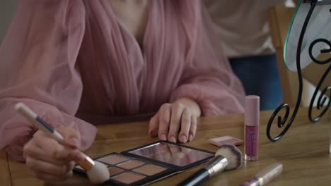 caucasian woman teaching daughter how to do make up for a prom