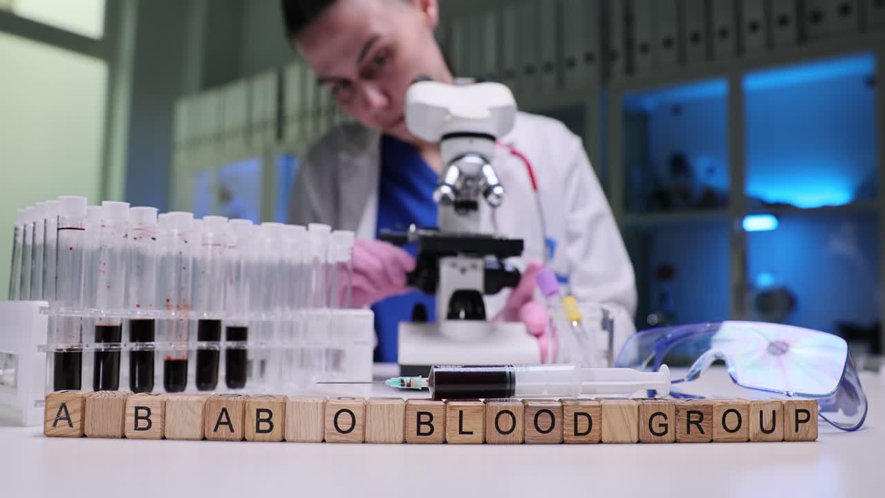Wooden cubes on laboratory table form words a b ab o blood group