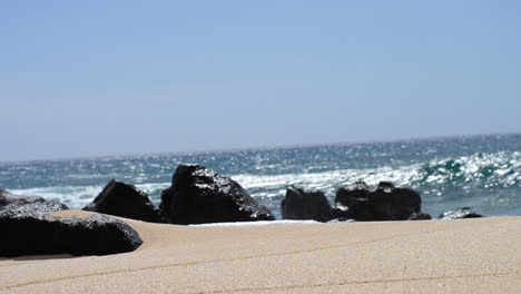 ocean waves crashing on rocks of north shore beach in hawaii