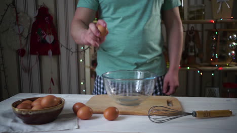 chef break egg. breaking egg into glass bowl. chef cooking food.