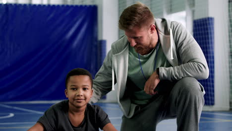 kid stretching on the indoor field