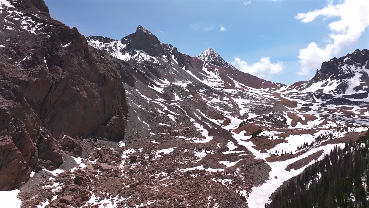Mt Mount Lindsey 14er North Ridge trail Blanca Peak Sangre De Cristo Range aerial drone Colorado spring summer snow fields melting morning blue sky clouds Rocky Mountains summit circle right motion