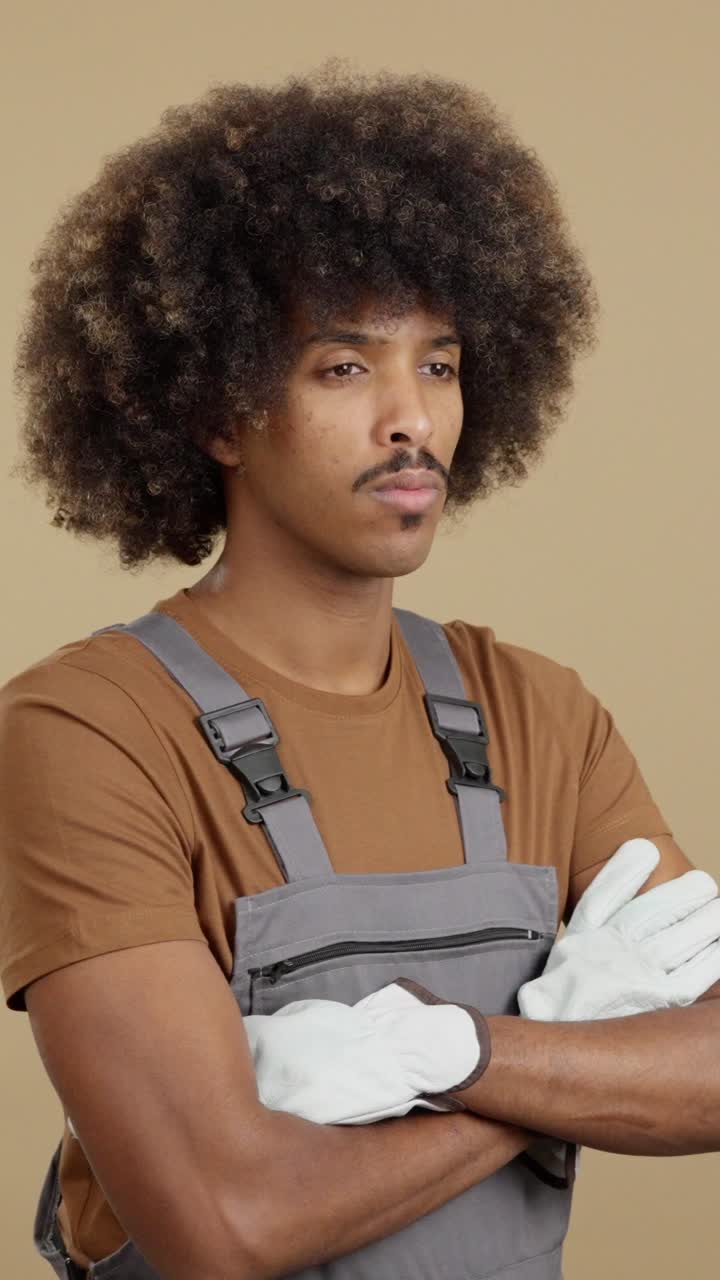 Man in Overalls with Afro and Gloves