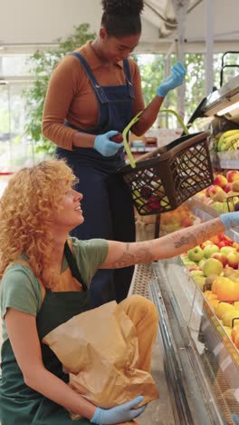 two women shopping for fresh produce at a grocery store