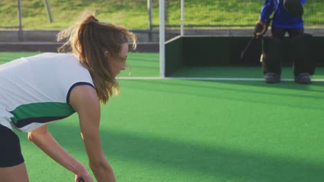 Female-hockey-players-playing-on-the-field