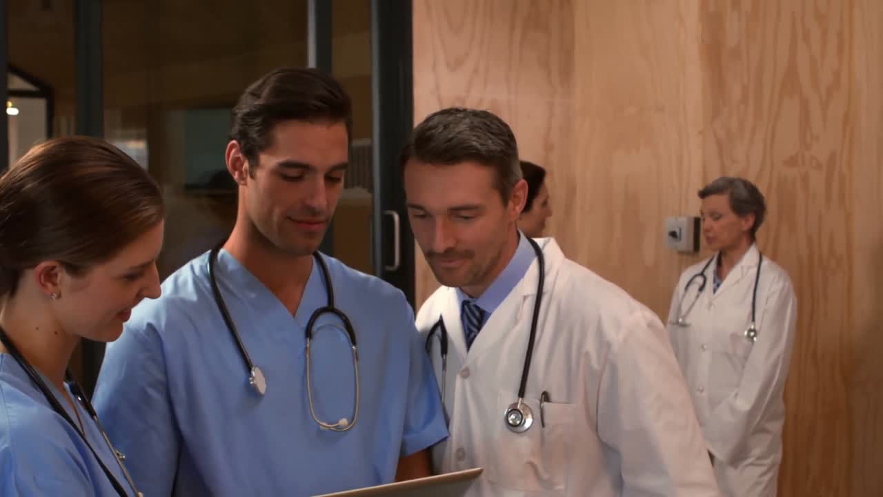 Doctors using tablet and talking
