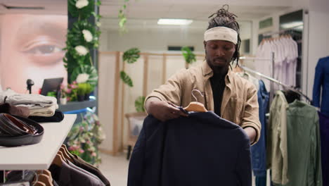 man buying shirts and blazers in mall