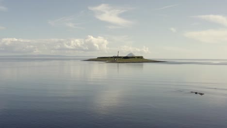 Aerial-view-of-Pladda-Lighthouse-on-the-Isle-of-Arran-on-a-sunny-day,-Scotland