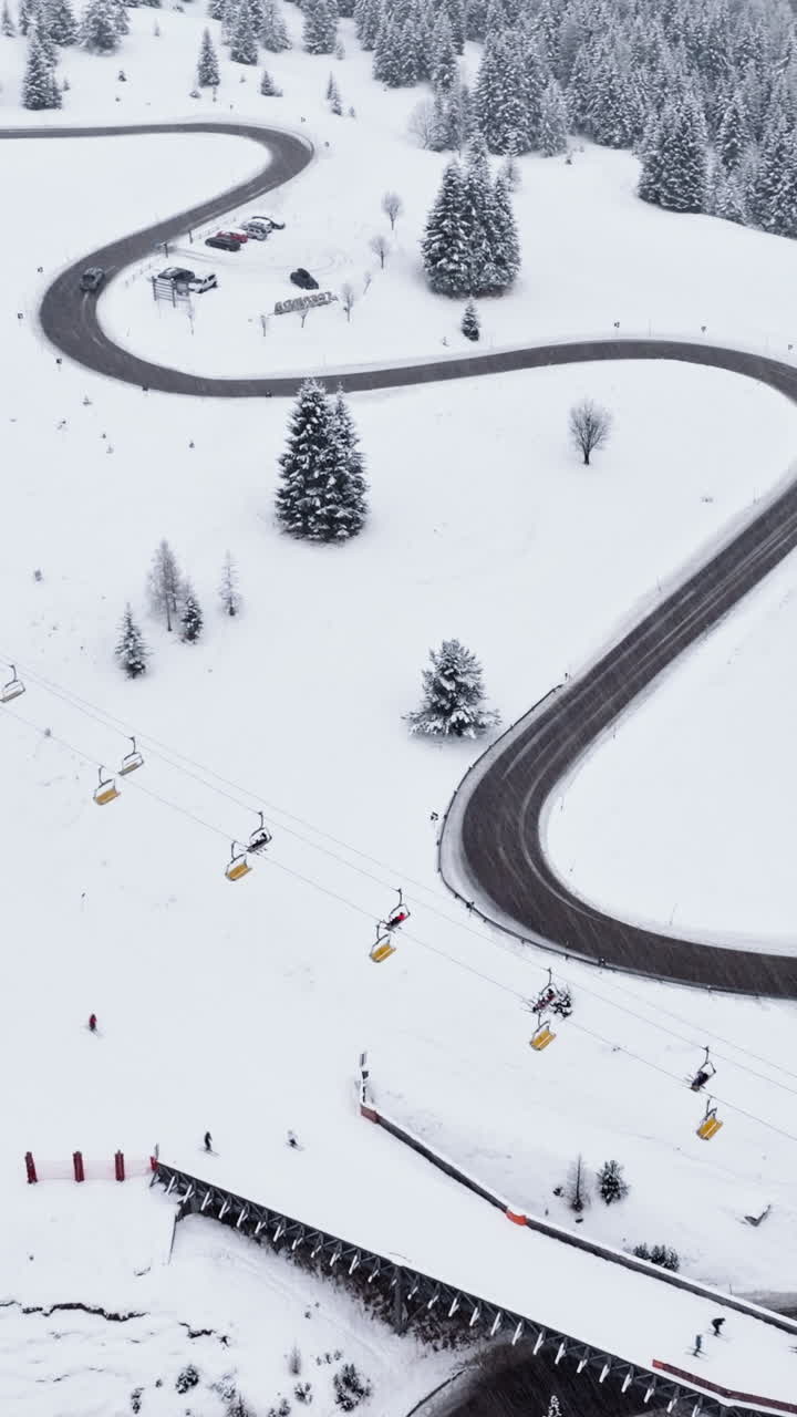 Aerial drone view of a ski lift in Corvara, in South Tyrol, the Dolomites. Vertical