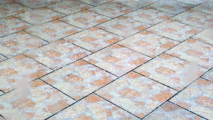 Hailstone fall on terrace tiles while storm