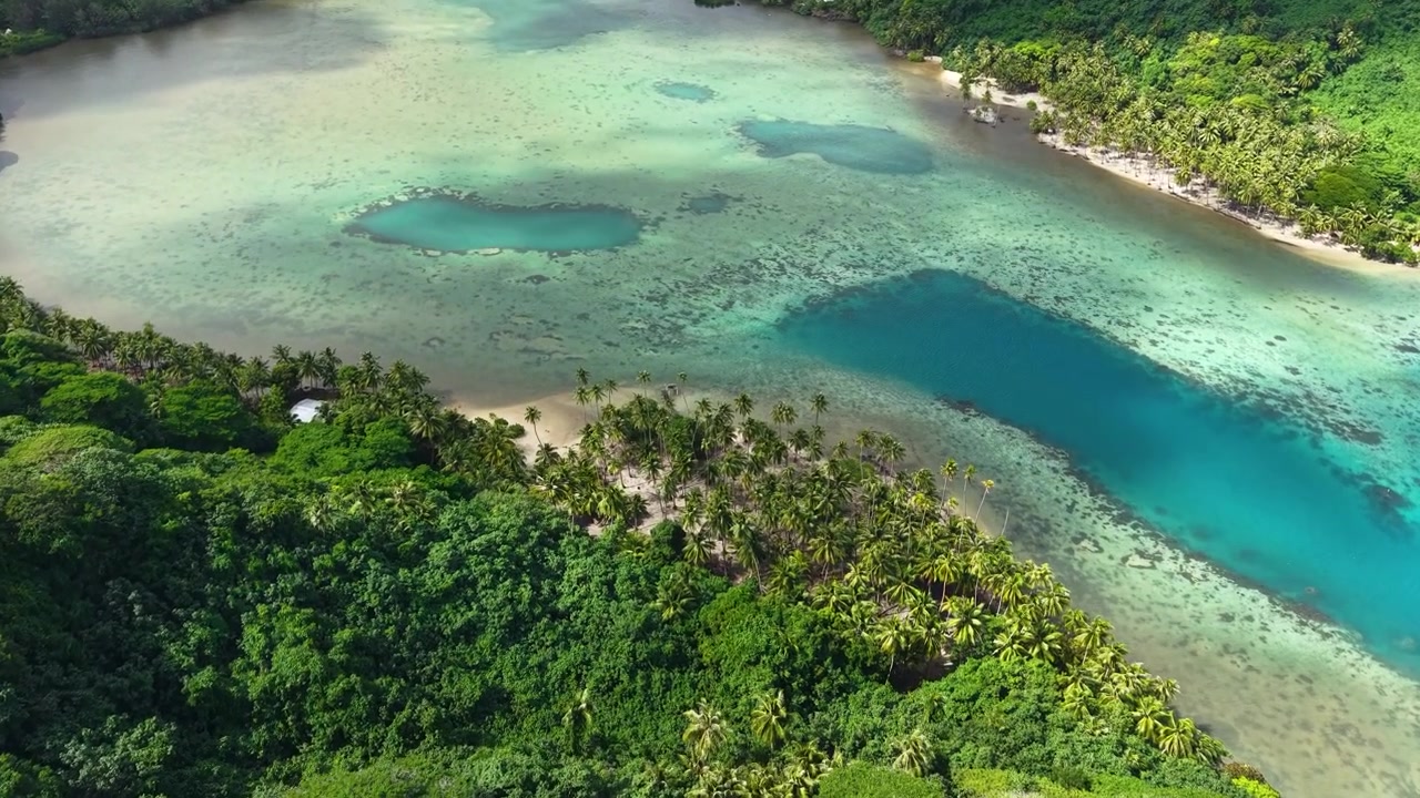 French Polynesia Huahine Island, Drone View of Bay With Coral Reefs, Beach and Tropical Rainforest Under Clouds Shadows