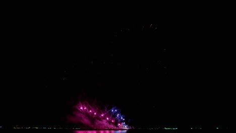 los fuegos artificiales de la víspera de año nuevo exhiben un bucle de celebración sin costuras de fondo de fuegos artificiales reales con un gran espectáculo de fuegos artificiales brillantes multicolores abstractos con luces bokeh en el cielo nocturno