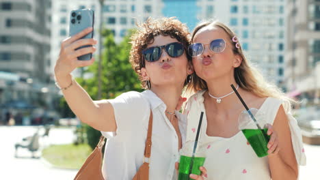 two friends taking a selfie outdoors