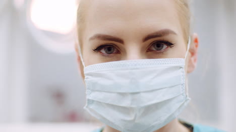 close up of female dentist looking at patient during surgey 1