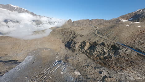 FPV drone flying through the exposed Weismies glacier above Saas-Grund, revealing deep crevasses, seracs, and signs of rapid glacial melt. The Swiss Alps in all its beauty