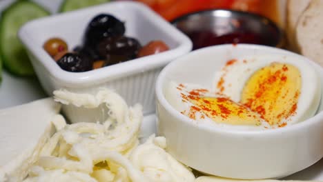 turkish breakfast with eggs, cheese, bread and olives