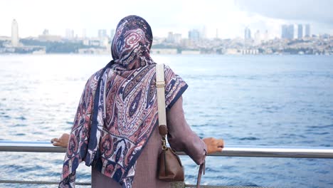 woman in hijab looking at the istanbul city view