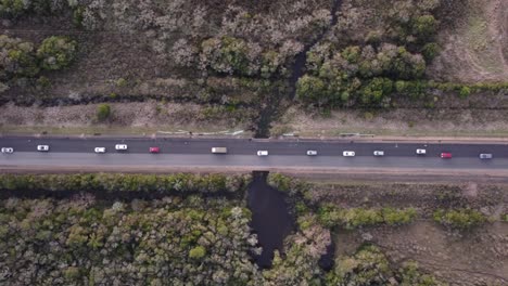 línea de autos haciendo cola en la carretera rectilínea rural de uruguay en américa del sur