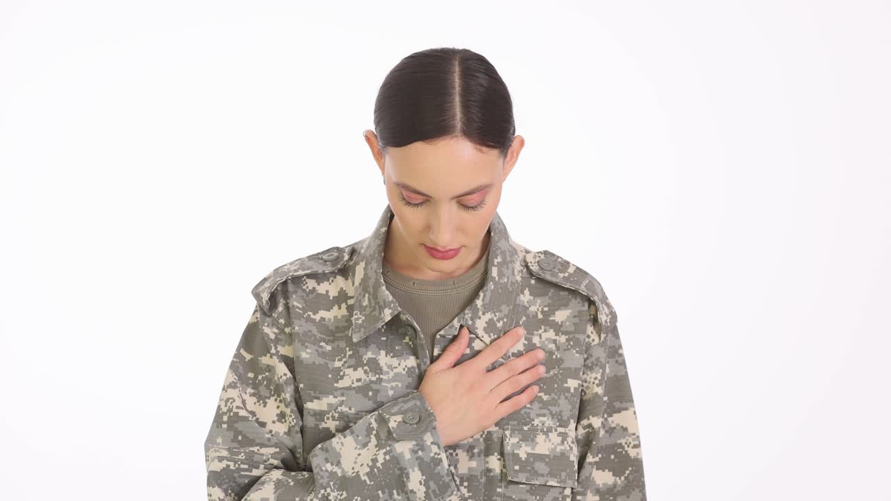 Woman Soldier in Camouflage Uniform with Hand on Heart