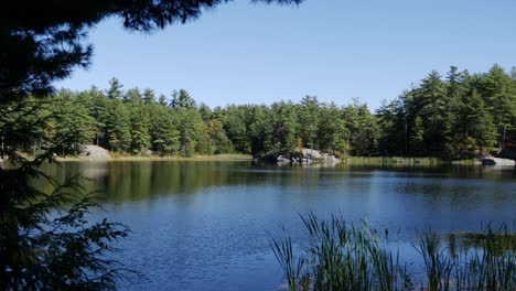 A-handheld-panning-shot-of-a-lake-on-a-New-England-mountain-during-autumn